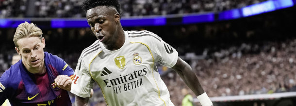 Soccer players from Real Madrid and Barcelona battle for the ball in a LaLiga duel